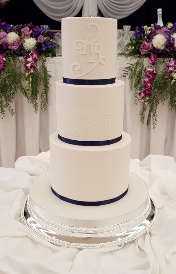 White Wedding Cake with Blue Ribbon