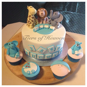 male baby shower cake with cupcakes and animal toppers
